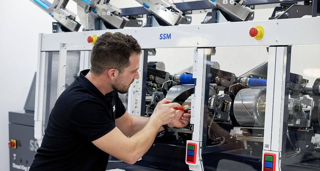 SSM specialist performing upgrades and retrofits on a winding machine to enhance efficiency and extend machine lifespan.