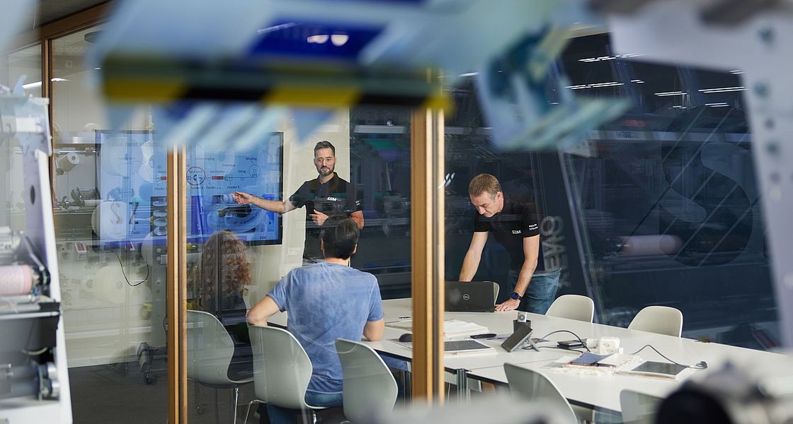 SSM textile experts conducting a customer training session at SSM Schärer Schweiter Mettler AG in Switzerland.