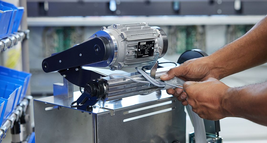 Technician preparing a motor for assembly on SSM winding machines