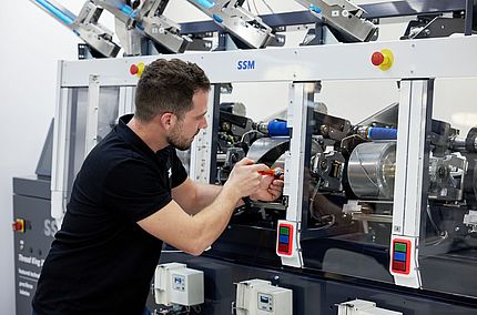 SSM specialist performing upgrades and retrofits on a winding machine to enhance efficiency and extend machine lifespan.